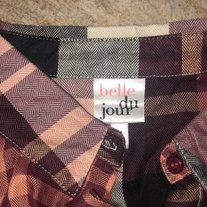 A button up//tied  flannel with rolled up sleeves with buttons